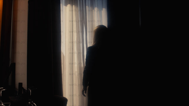 Businesswoman opens curtains in hotel room, city view, new opportunities
