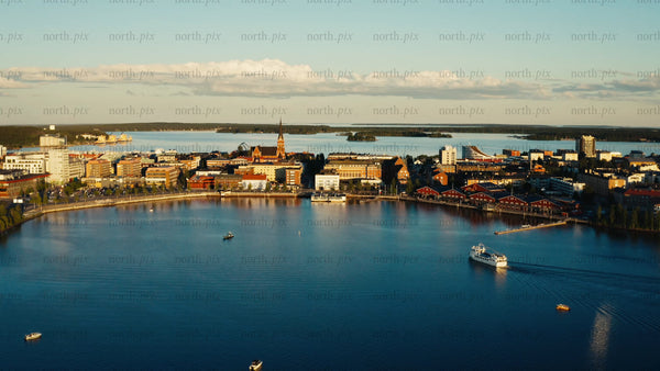 Summer evening in Luleå: Aerial view of city skyline, port, and boats on the water