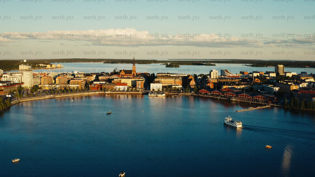 Summer evening in Luleå: Aerial view of city skyline, port, and boats on the water