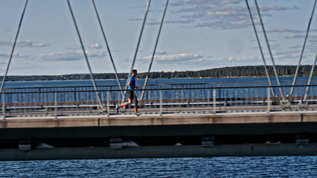 Man Running Across Bergnäsbron Bridge in Luleå, Sweden, on a Sunny Summer Day