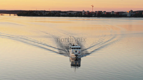 Golden Hour Ferry Commute Across the Lulea River in Lulea, Sweden on a Summer Evening