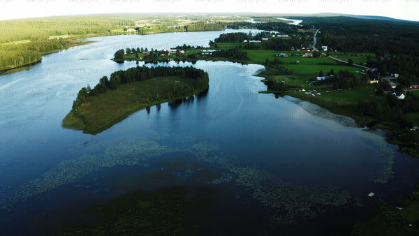 Summer evening drone view of Luleå: Lake and rural landscape