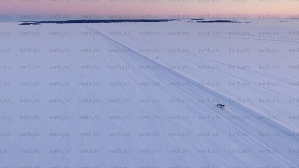 Driving on a frozen ice road at sunset in the Luleå archipelago