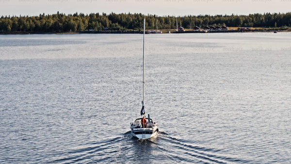 Aerial view of sailboat in the Swedish archipelago of Luleå on a summer evening