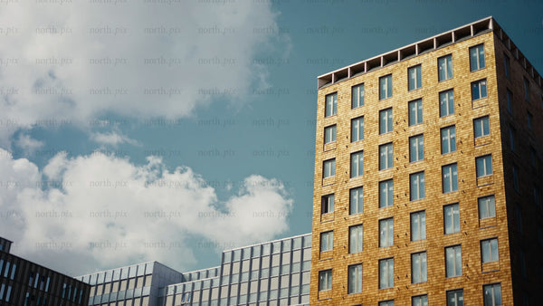 Modern wooden architecture building against blue sky and white clouds