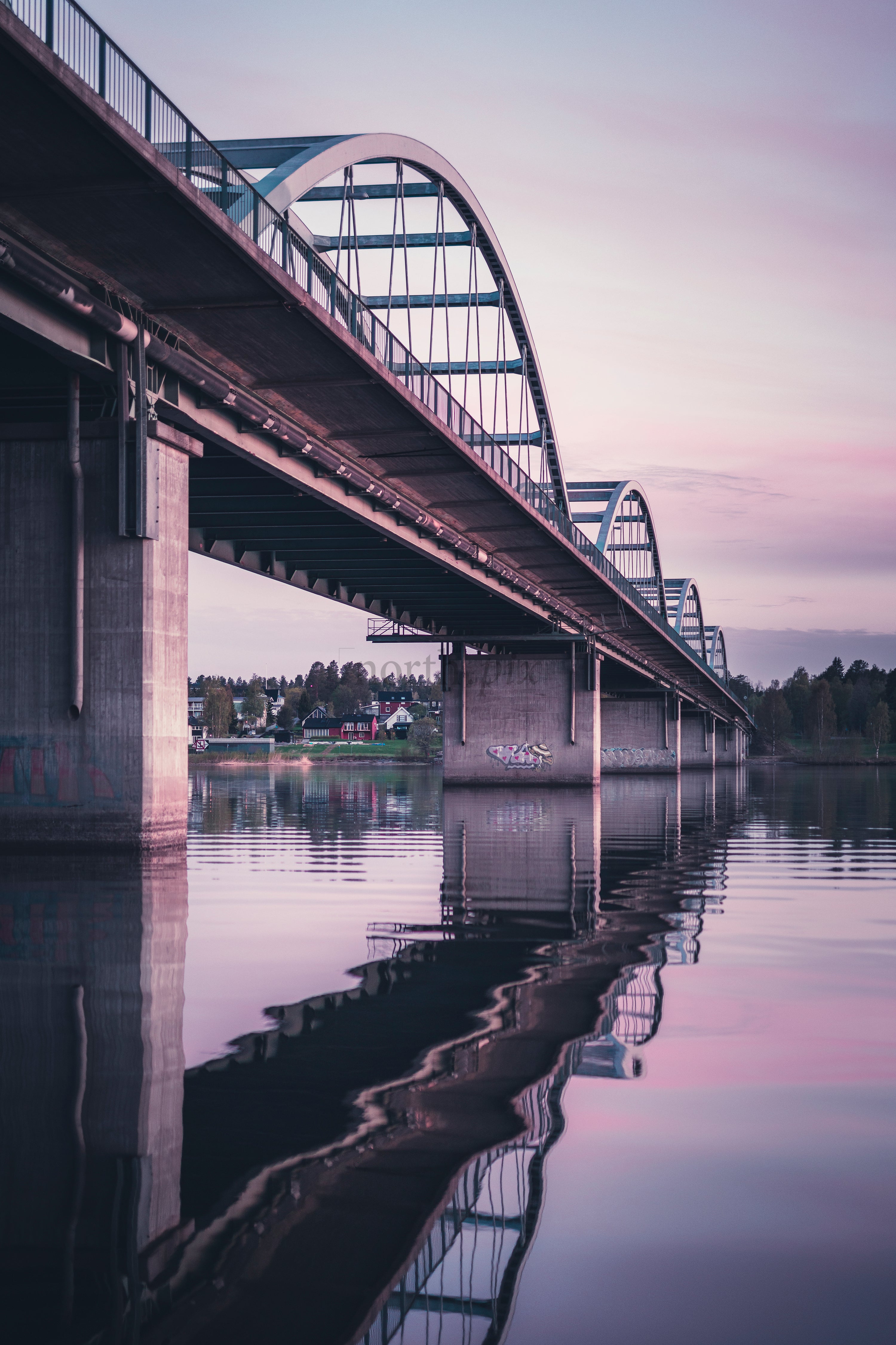 Bergnäsbron - Arched bridge over river with reflection at dusk