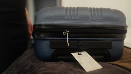 Woman Closing Suitcase in Hotel Room Getting Ready for Business Trip
