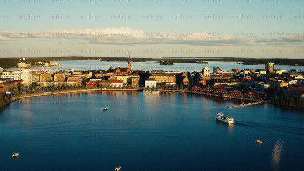 Summer evening in Luleå: Aerial view of city skyline, port, and boats on the water