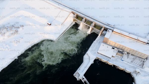 Aerial view of hydroelectric power plant in snowy winter landscape