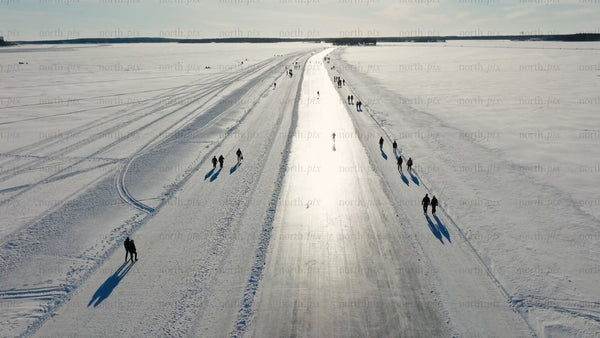 Winter ice skating and walking on frozen lake in Luleå