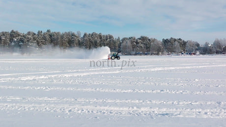 Tractor Clearing Snow on Frozen Lake in Lulea, Sweden Winter Landscape