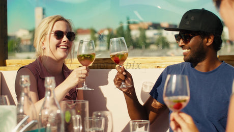 Friends Enjoying Summer Cocktails at a Rooftop Bar in Luleå, Sweden