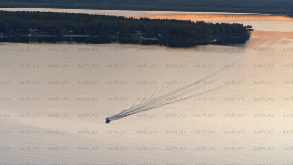 Summer sunset boat ride on a lake in Luleå: An aerial view of beauty