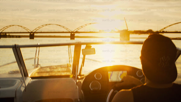 Boating on the Luleå river at sunset during golden hour, Luleå Sweden