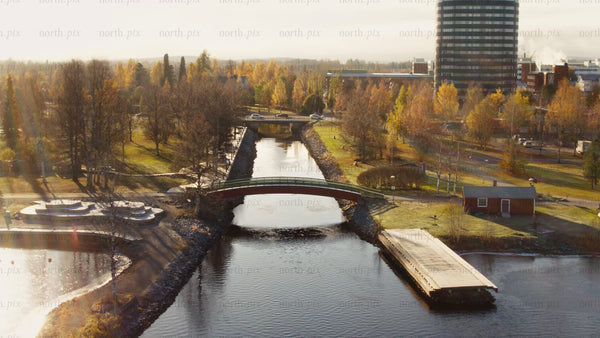 Piteå city's autumn charm: A person walks across a bridge over the canal