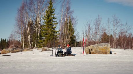 Winter Break: Skiers Enjoying Warm Drinks in Snowy Luleå, Sweden Forest
