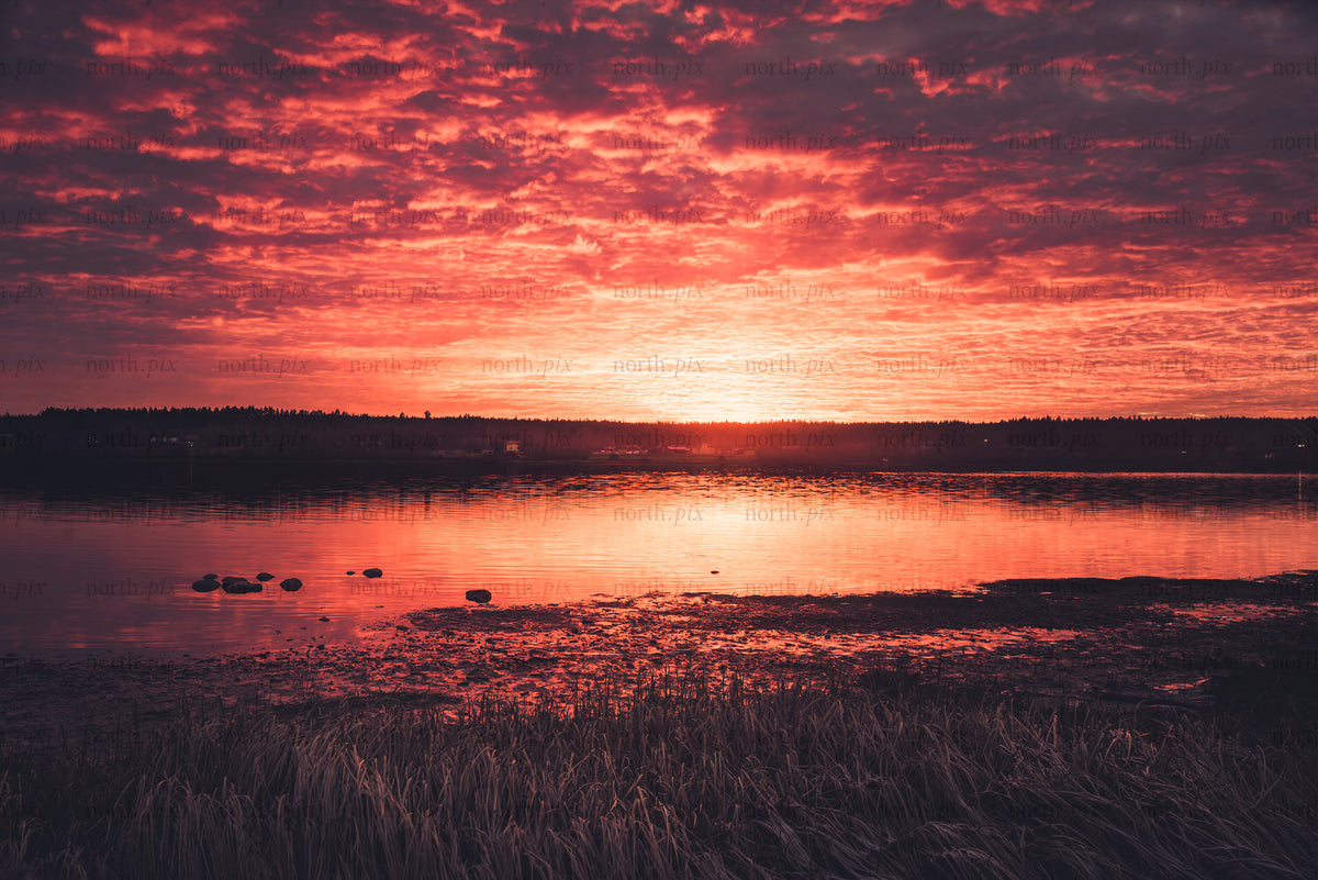 Sunset over a lake with reflected cloud cover