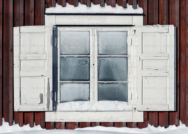 Old wooden window with shutters and snow