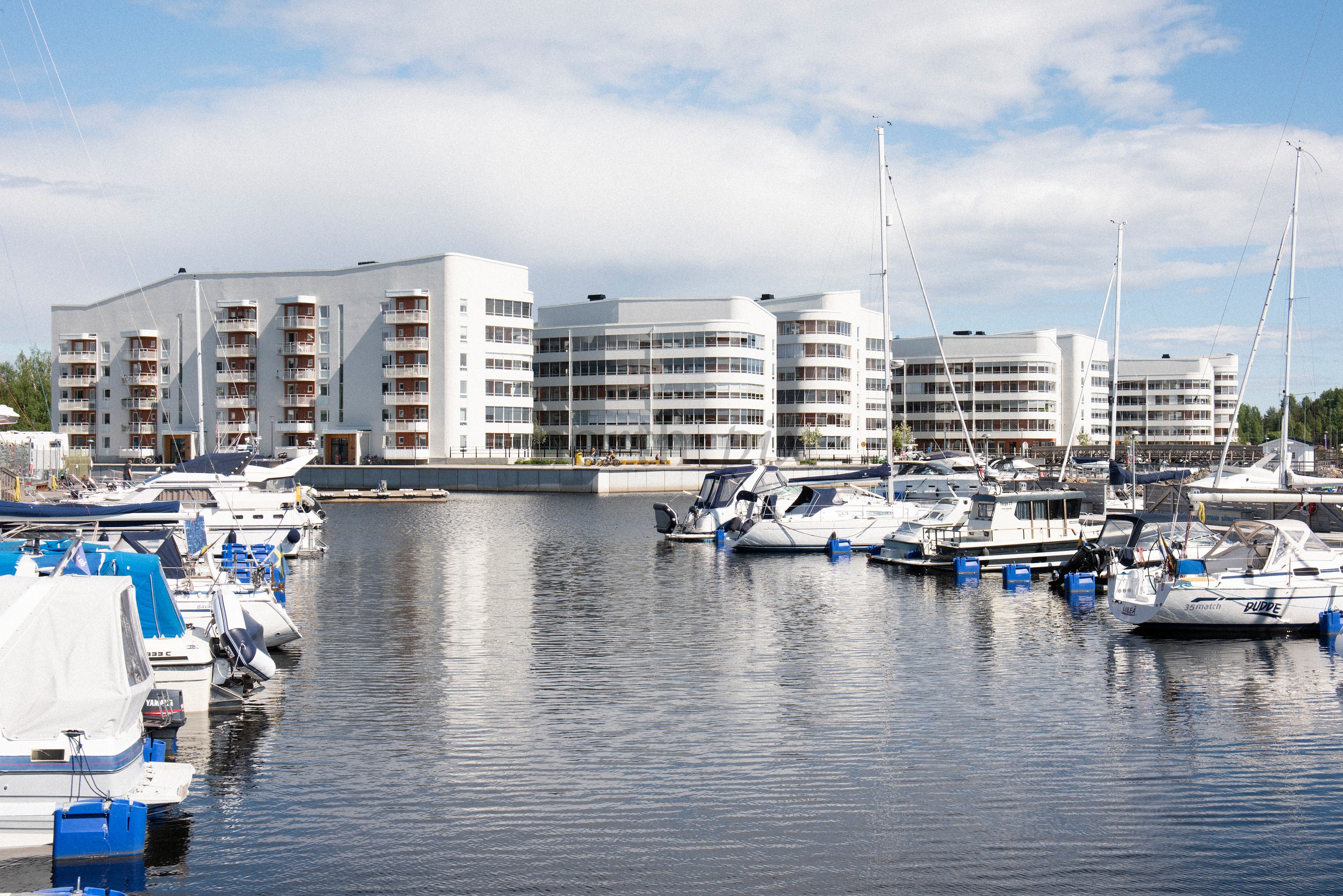 Marina with waterfront apartment buildings at midday