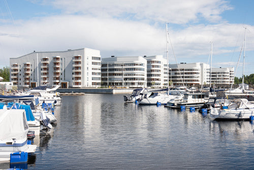 Marina with waterfront apartment buildings at midday