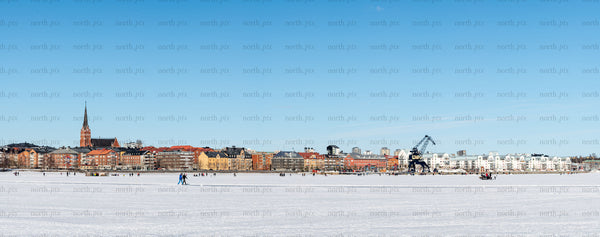Town skyline with frozen bay in winter daytime