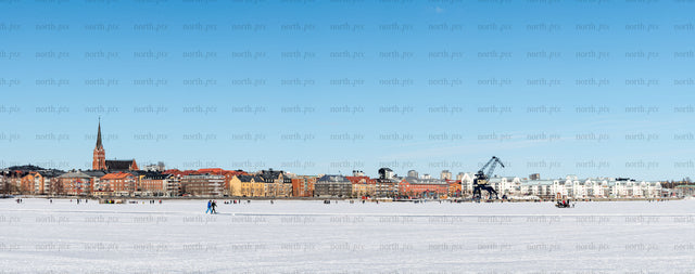 Town skyline with frozen bay in winter daytime