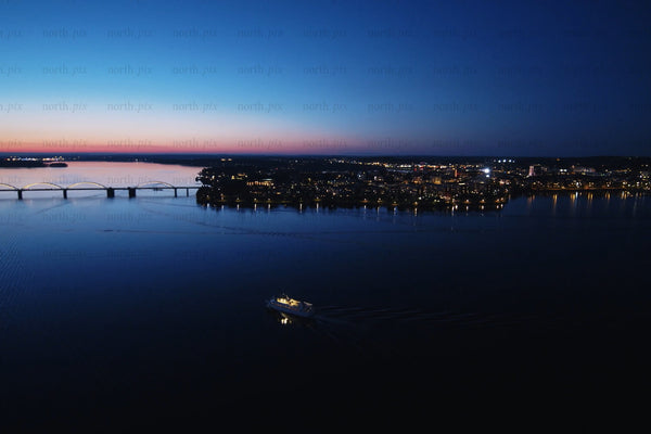 Twilight city center over the river with bridge, boat and city Lights in Luleå