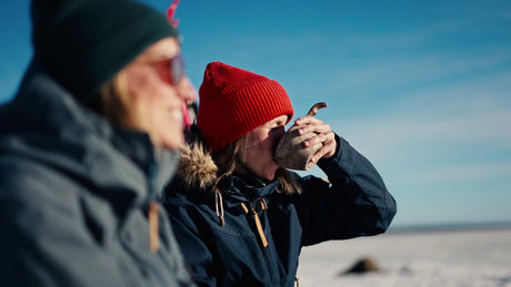 Two Women Enjoying a Warm Drink in the Winter Landscape of the Luleå Archipelago, Sweden