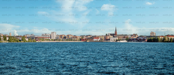 Summer city skyline across waterfront with church steeple